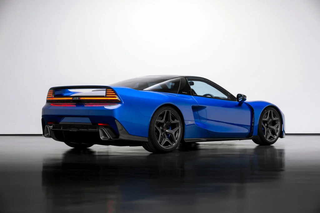 Rear three-quarter view of a blue JAS Tensei in a white studio, with a full-width rear light bar and a carbonfibre diffuser