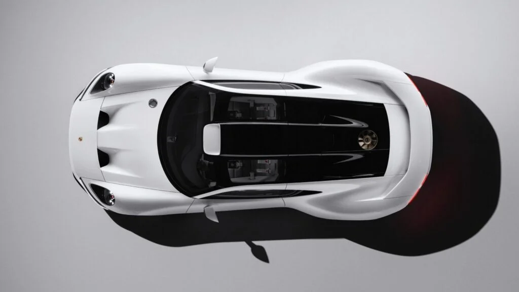 White Porsche Mission S concept photographed from directly above in a grey studio, showing its black roof and sculpted front and rear wings
